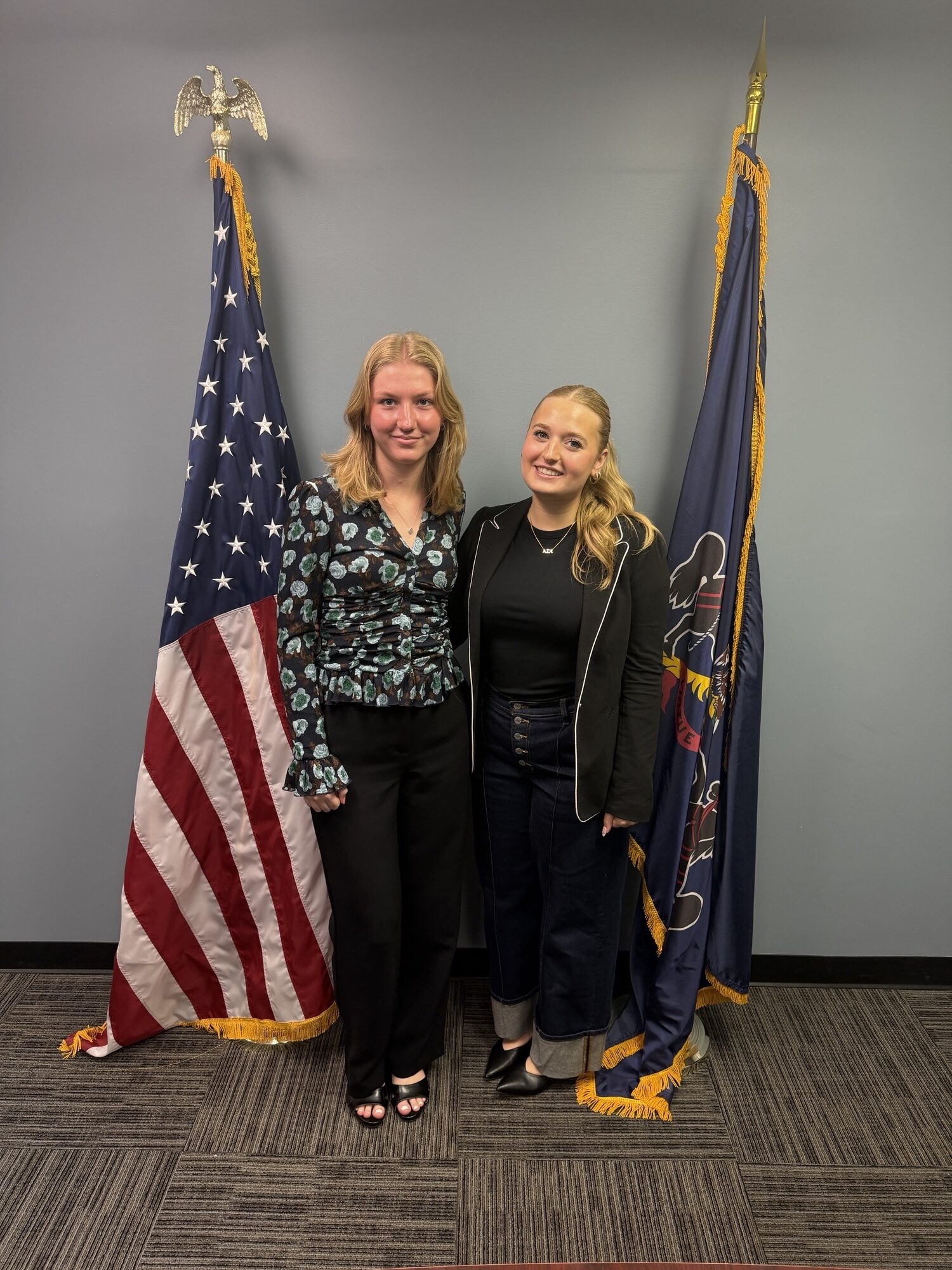 Sen. Brown’s interns, Jess (left) and Caroline (right), pose for a picture in front of both the Pennsylvania Flag and American Flag.