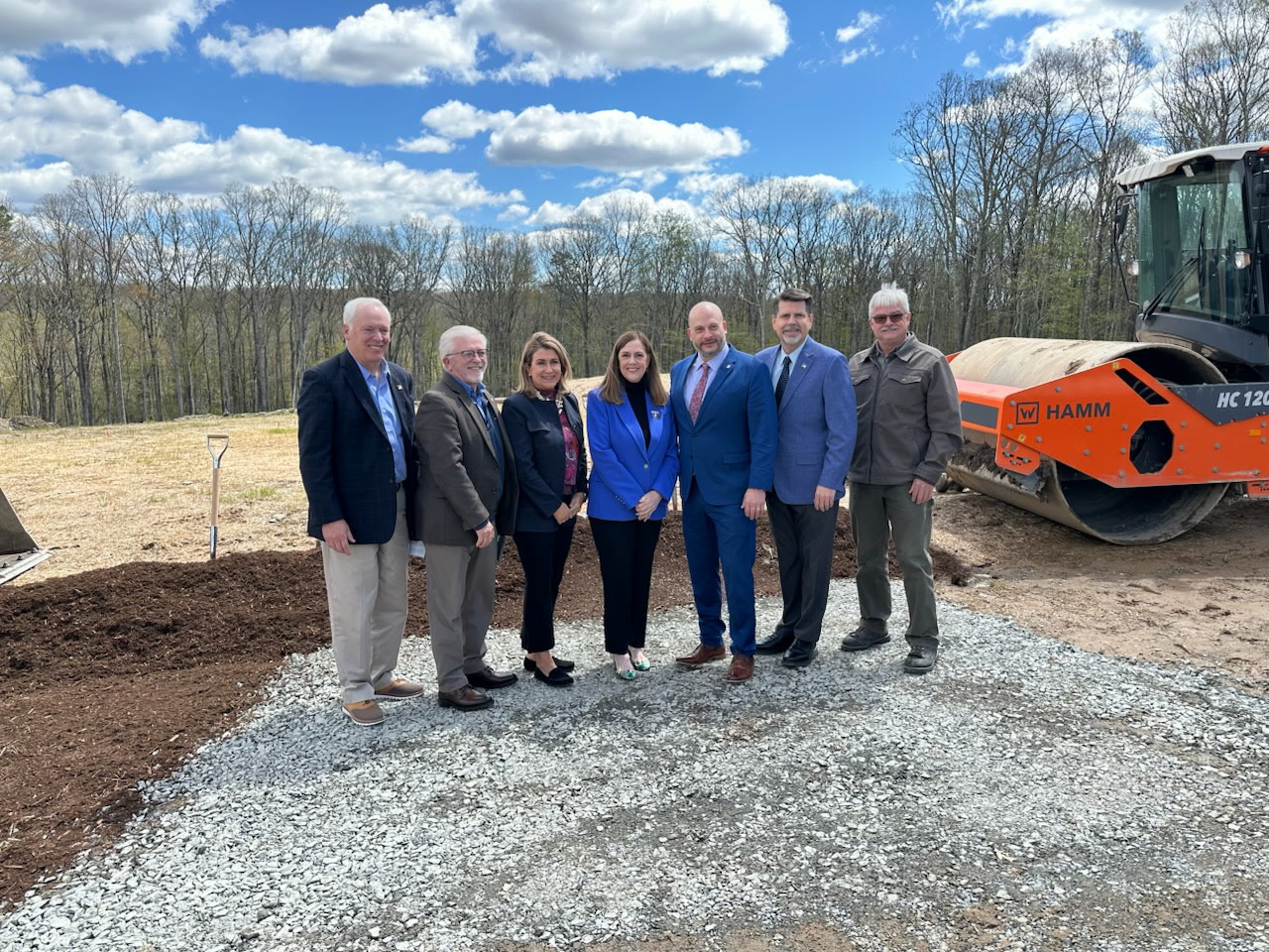 Sen. Brown, Sen. Baker, Rep. Fritz, and Rep. Olsommer pose for a picture in front of the wood line of the construction site for Pete’s Sake Cancer Respite Center, with construction equipment behind the group.