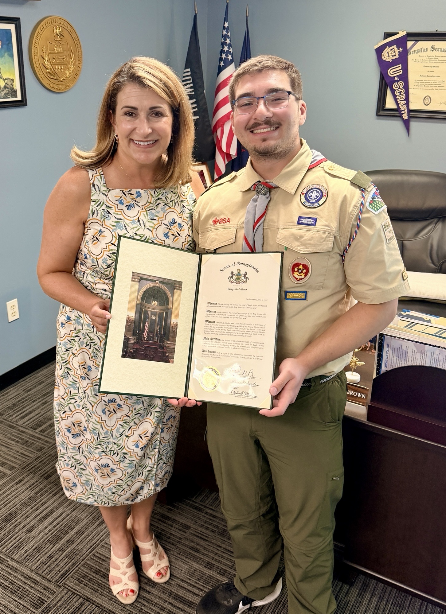 Sen. Rosemary Brown stands with Eagle Scout Nicolas Petroff, congratulating him on reaching this great accomplishment. They are both holding a Citation from the Senate of Pennsylvania, standing in her District Office.