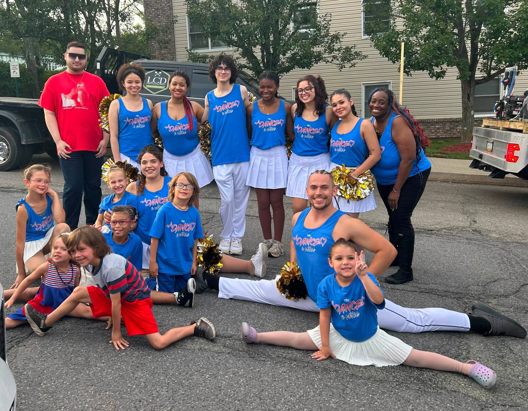 Group of people with blue dance shirts on.
