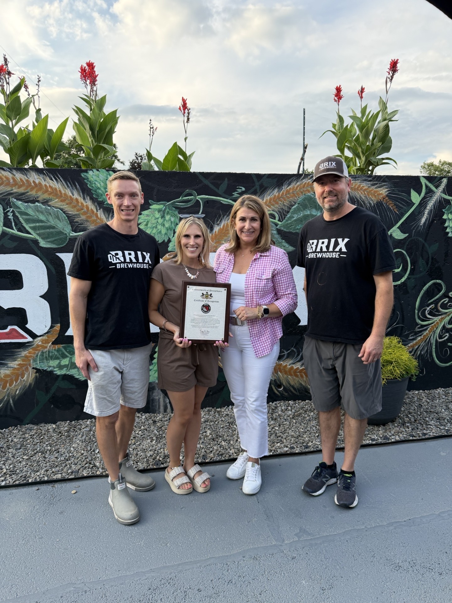 Sen. Rosemary Brown poses with a Plaque from the Senate of Pennsylvania honoring the grand opening of Brix Brewhouse in Brodheadsville. She is posing with co-owners, Joe and Chris.